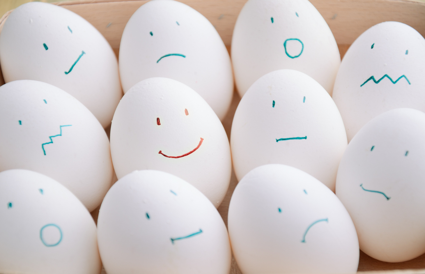 white eggs with different emotions  in tray horizontal